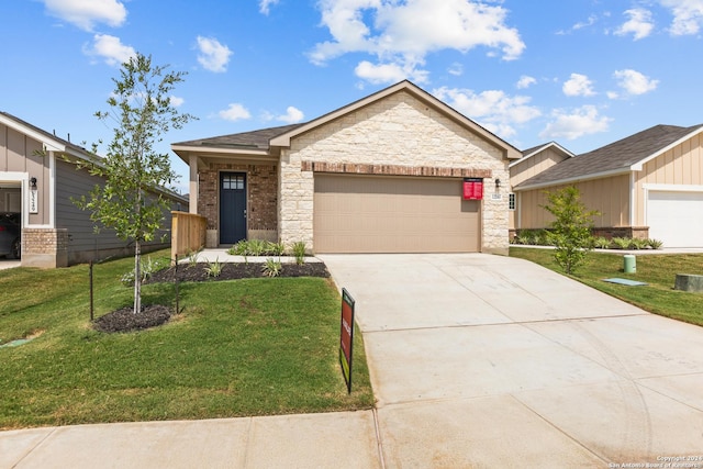 view of front of property featuring a front yard and a garage