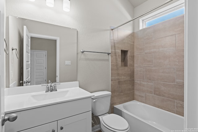 full bathroom featuring vanity, toilet, and tiled shower / bath