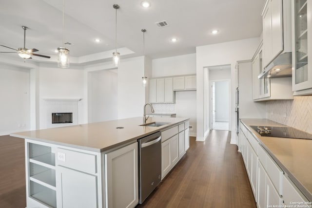 kitchen featuring sink, dark hardwood / wood-style floors, an island with sink, white cabinets, and stainless steel dishwasher