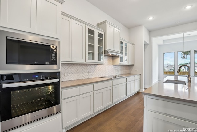 kitchen featuring white cabinetry, stainless steel appliances, sink, and decorative backsplash