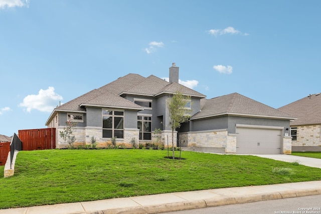 view of front facade featuring a garage and a front lawn