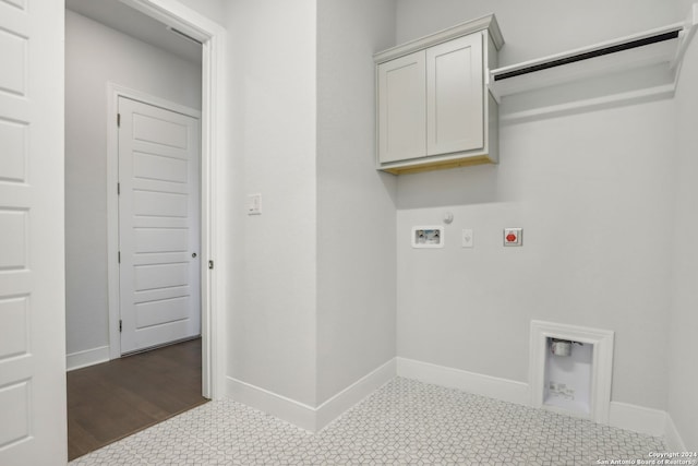 clothes washing area with cabinets, hookup for a gas dryer, hookup for a washing machine, and electric dryer hookup