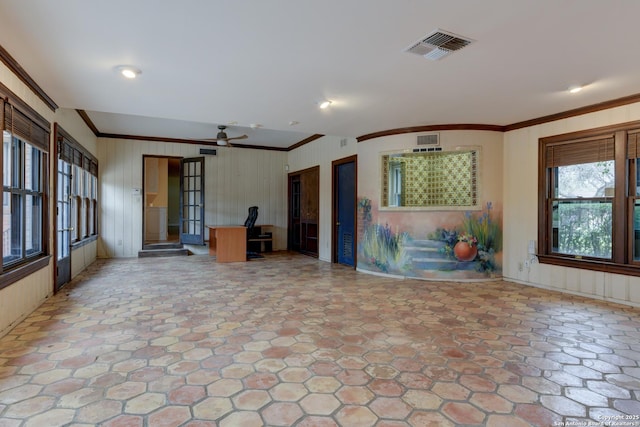 interior space with ceiling fan and ornamental molding