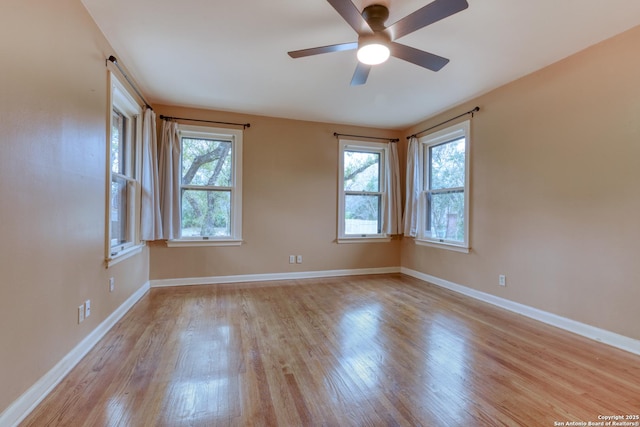 spare room featuring ceiling fan and light hardwood / wood-style flooring