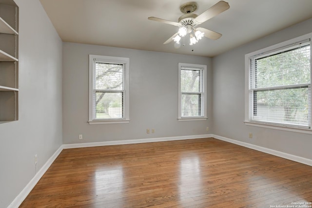 empty room with wood-type flooring and ceiling fan