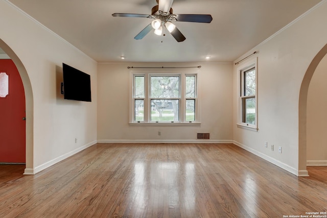 unfurnished room with ceiling fan, ornamental molding, and light wood-type flooring