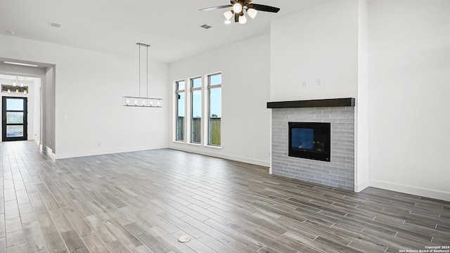 unfurnished living room featuring hardwood / wood-style flooring and ceiling fan