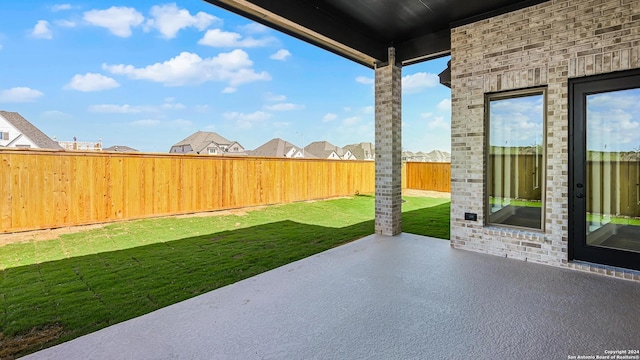 exterior space with a patio area, a fenced backyard, and a residential view