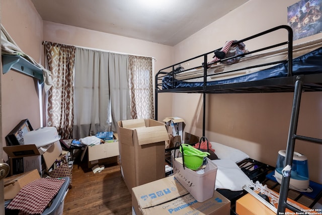 bedroom with dark hardwood / wood-style flooring