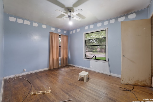 unfurnished room featuring hardwood / wood-style flooring and ceiling fan