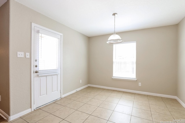 unfurnished dining area featuring light tile patterned flooring and a healthy amount of sunlight