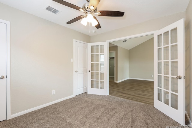 carpeted spare room with french doors and ceiling fan