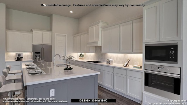 kitchen with white cabinetry, a center island with sink, stainless steel appliances, and sink