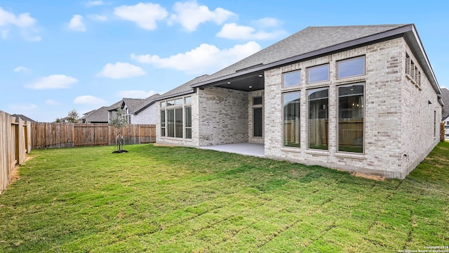 back of property featuring a patio and a lawn