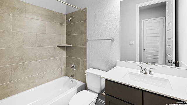 full bathroom featuring vanity, toilet, and tiled shower / bath