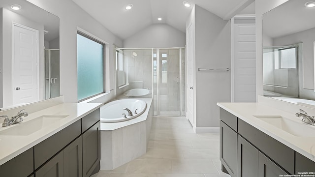 bathroom with plenty of natural light, lofted ceiling, and vanity