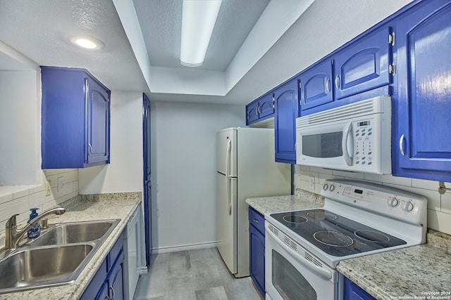 kitchen featuring decorative backsplash, sink, blue cabinetry, a tray ceiling, and white appliances