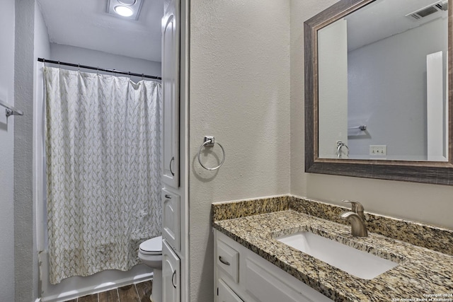 full bathroom featuring shower / tub combo, vanity, toilet, and hardwood / wood-style floors