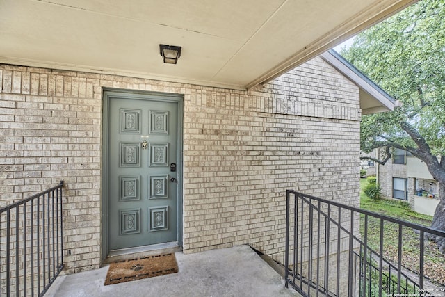 property entrance with brick siding