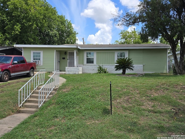 ranch-style home with a front lawn