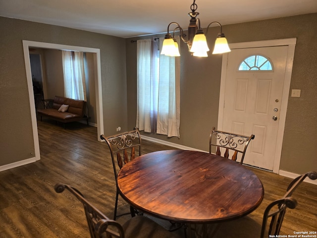 dining area featuring an inviting chandelier and dark hardwood / wood-style flooring