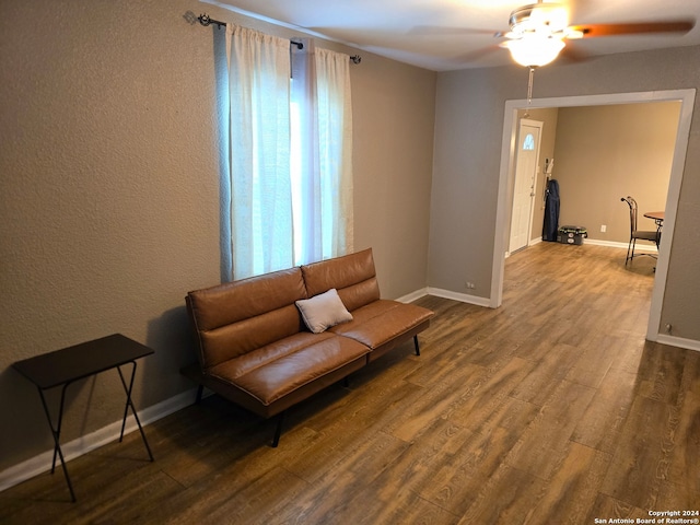 living area with ceiling fan and hardwood / wood-style floors