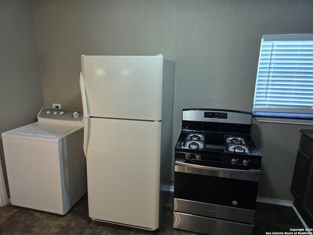 laundry area featuring a textured wall, laundry area, and washer / clothes dryer