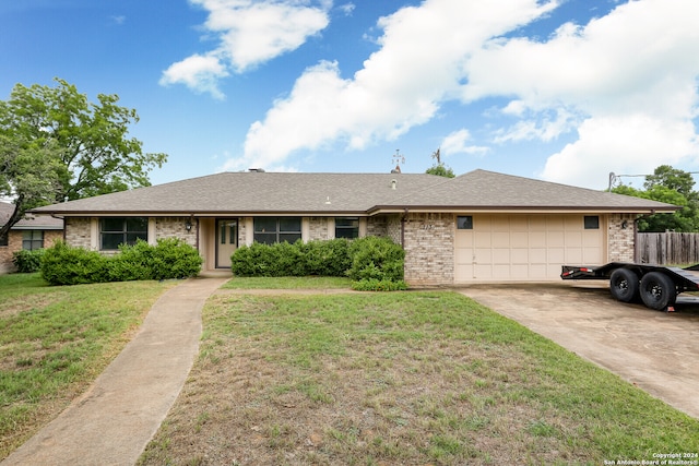 single story home with a garage and a front lawn