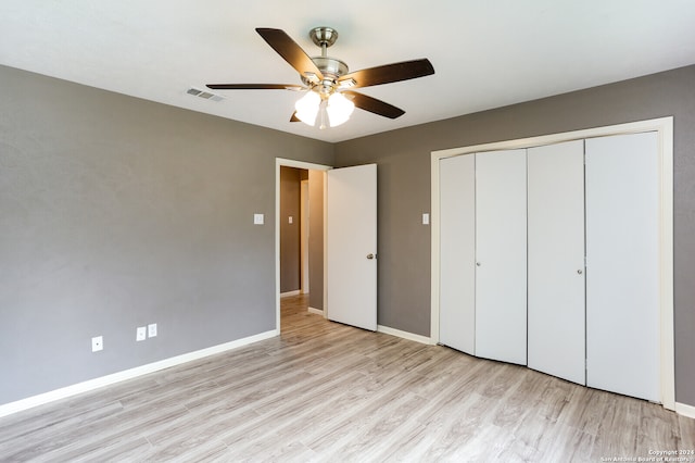 unfurnished bedroom featuring a closet, ceiling fan, and light hardwood / wood-style flooring