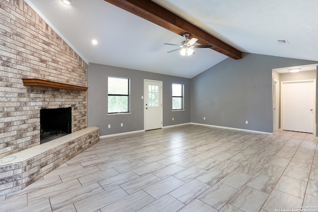 unfurnished living room with lofted ceiling with beams, a brick fireplace, light tile floors, and ceiling fan