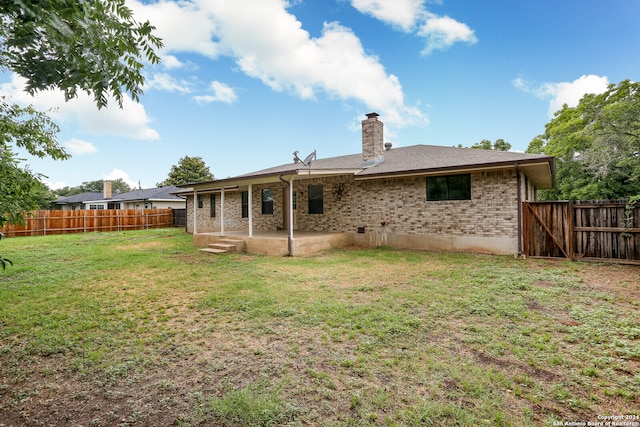 back of house with a lawn