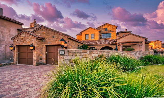 mediterranean / spanish house with a garage