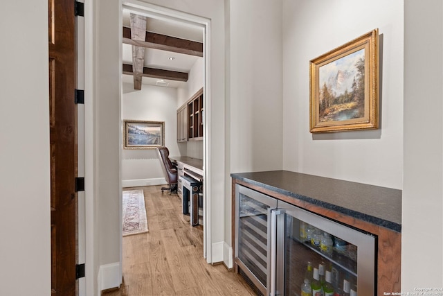 hall featuring beam ceiling, light wood-type flooring, and beverage cooler