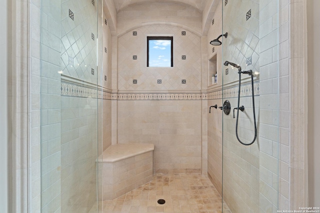 bathroom featuring a shower with shower door