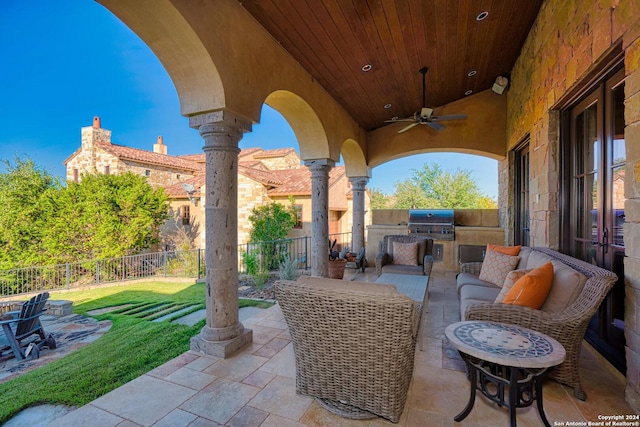 view of patio / terrace with a grill, ceiling fan, and an outdoor kitchen