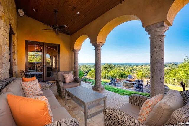 view of patio with french doors, an outdoor living space with a fire pit, and ceiling fan