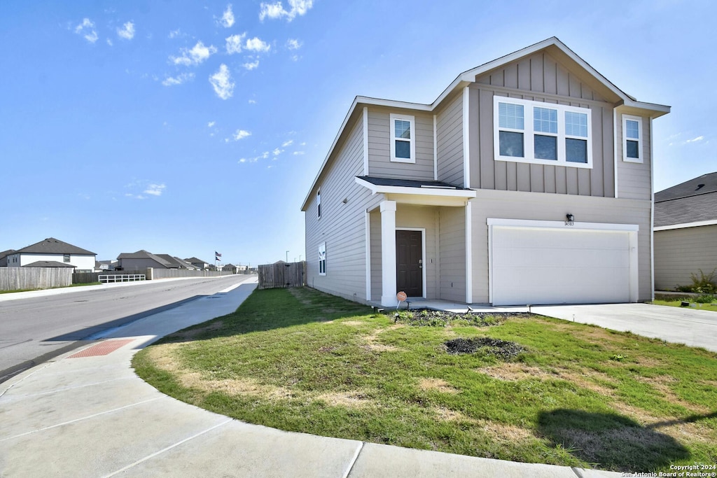 view of front of home with a front lawn and a garage