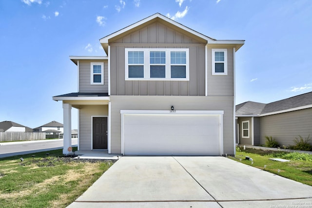 view of front of home featuring a front yard and a garage