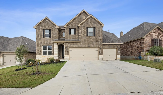 view of front facade with central AC, a front lawn, and a garage