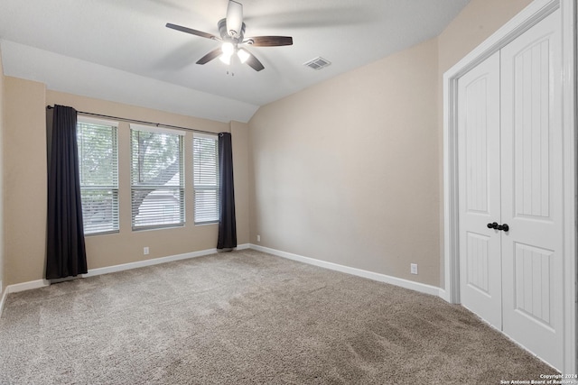 unfurnished room featuring lofted ceiling, carpet floors, and ceiling fan