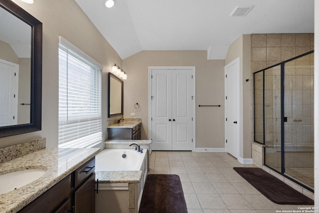 bathroom featuring tile patterned flooring, vaulted ceiling, separate shower and tub, and vanity