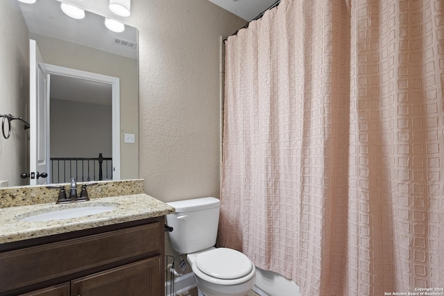 full bathroom featuring shower / tub combo, vanity, and toilet