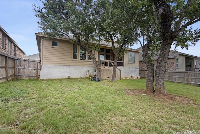 back of house with a yard