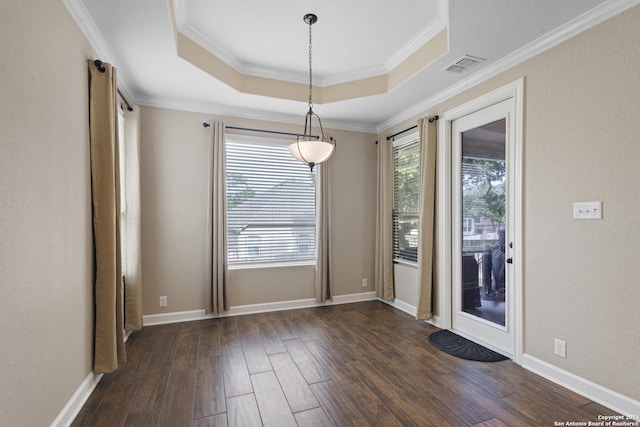 unfurnished dining area featuring crown molding, a raised ceiling, and dark wood-type flooring