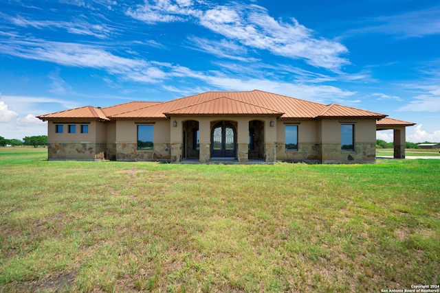 rear view of house featuring a yard