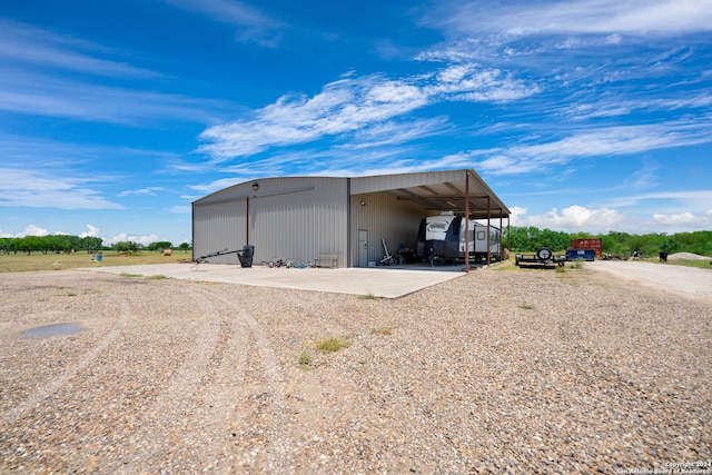 view of shed / structure with a carport and a garage