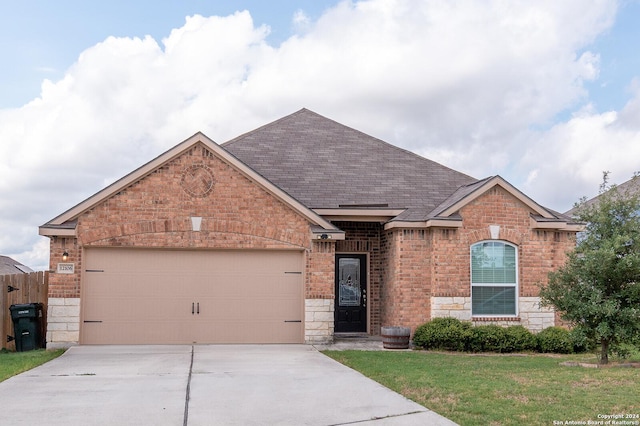 view of front of home with a garage and a front lawn