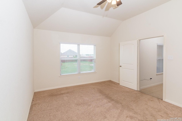 spare room with light colored carpet, ceiling fan, and lofted ceiling