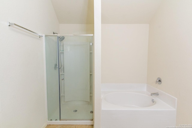 bathroom featuring tile patterned flooring and separate shower and tub