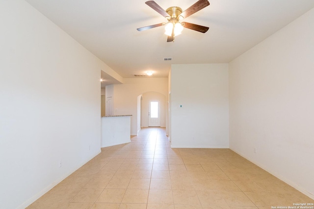 spare room with ceiling fan and light tile patterned flooring